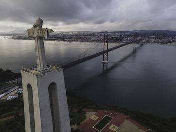 View of bridge over sea against cloudy sky