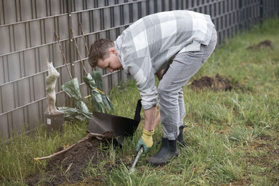 Side view of man working on field