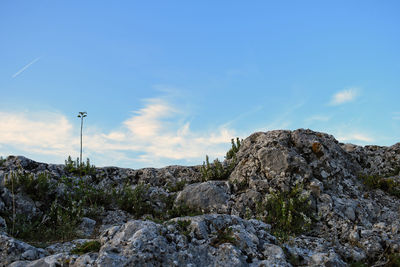 Low angle view of rock formation against sky