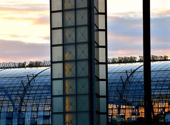 Modern building against sky during sunset