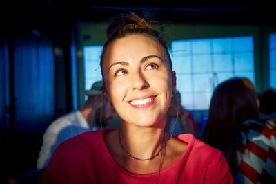 Portrait of a young woman in light, with dental diamond piercing person