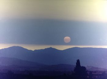 Scenic view of silhouette mountains against sky at sunset