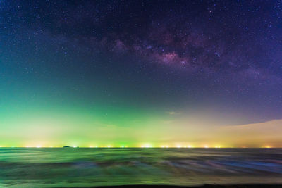 Scenic view of sea against star field at night