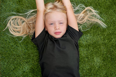 High angle view of young woman standing on grassy field