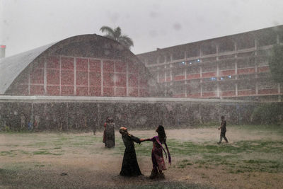 People enjoying rain on field