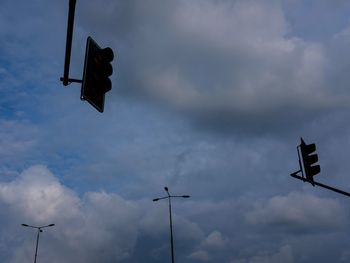 Low angle view of road sign against sky