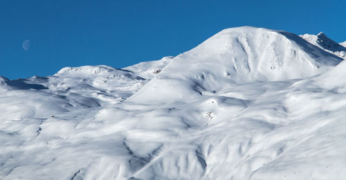 Scenic view of snow covered mountains