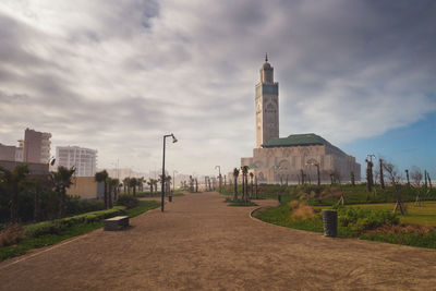 View of cityscape against cloudy sky