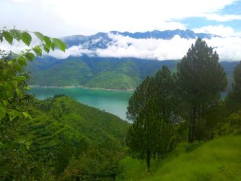 Scenic view of lake and mountains against sky