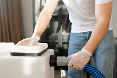 Midsection of man cleaning car