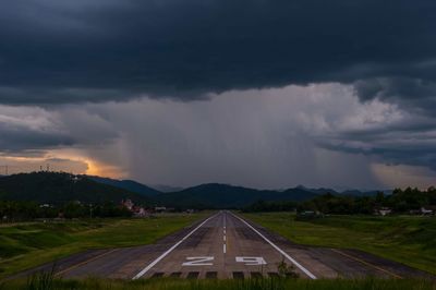 Panoramic view of storm clouds over road