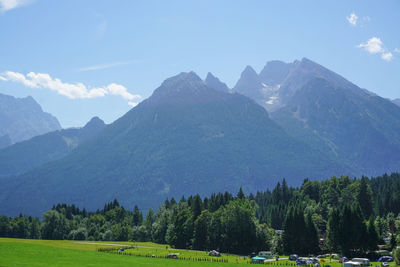 Scenic view of field and mountains against sky