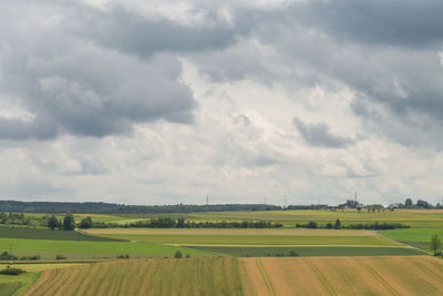 Idyllic shot green landscape against cloudy sky