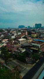 High angle view of buildings in city against sky