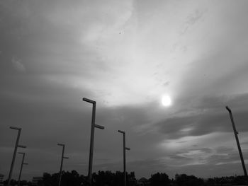 Low angle view of street light against cloudy sky