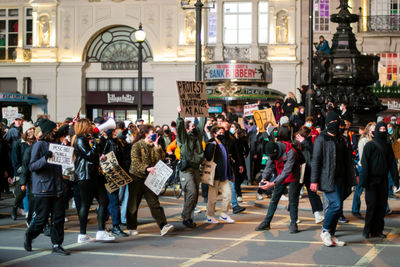 Group of people walking on city street