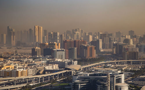 Aerial view of modern buildings in city against sky