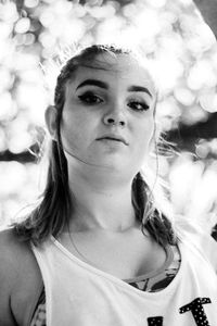 Portrait of young woman exercising in park