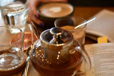 Moroccan tee and coffee on a wooden plate in a coffee shop with grape slice and books opened