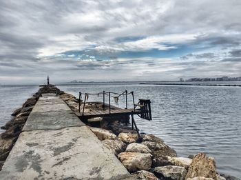 Pier over sea against sky