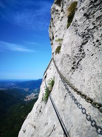 Low angle view of rocks on mountain against sky