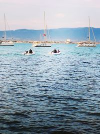 Sailboats sailing on sea against sky