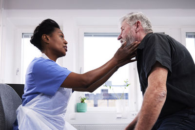 Female doctor examining patient's neck