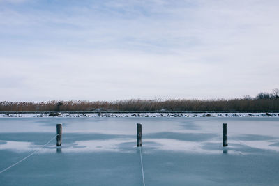 Scenic view of frozen lake against sky during winter