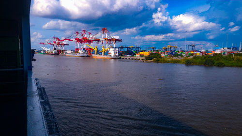 Commercial dock by sea against sky