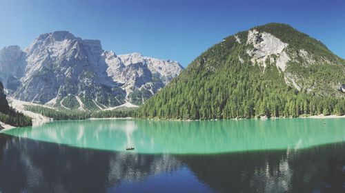 Scenic view of lake and mountains against blue sky