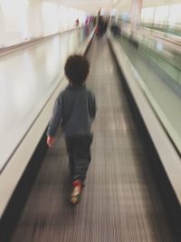 Blurred motion of people on escalator