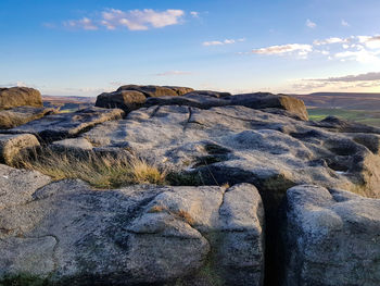 Rock formations on landscape against sky