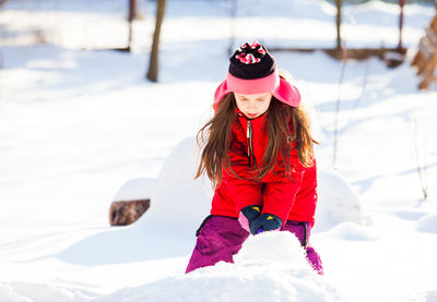 Rear view of girl with umbrella during winter