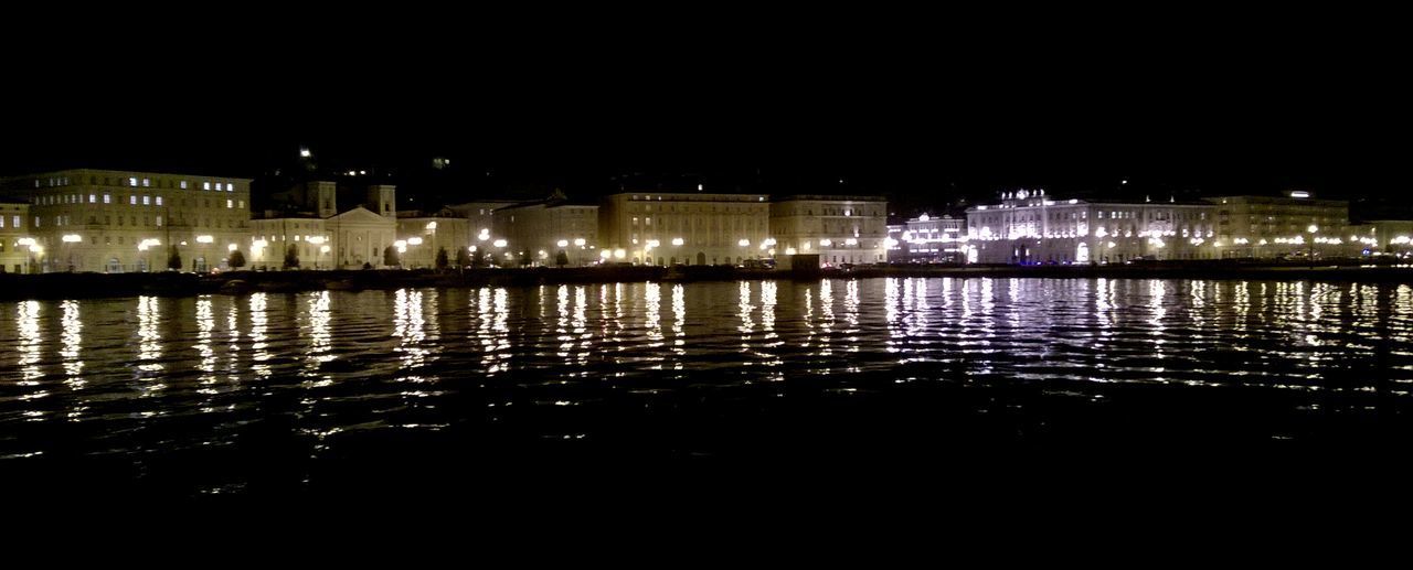 VIEW OF ILLUMINATED CITY AT NIGHT