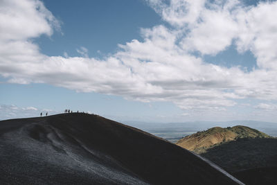 Scenic view of mountains against cloudy sky