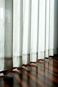 Close-up of curtain on hardwood floor
