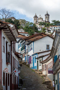 Houses in town against sky in city