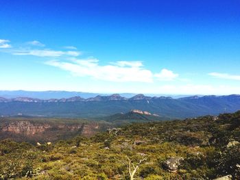 Scenic view of landscape against blue sky