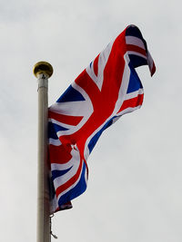 Low angle view of flag against sky