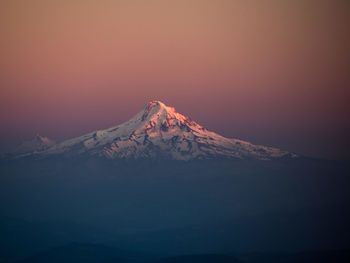 Scenic view of snowcapped mountain against sky at night