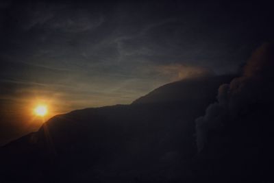 Scenic view of silhouette mountains against sky during sunset