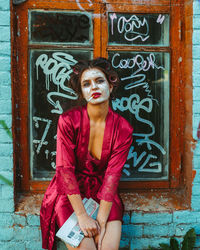 Portrait of woman standing on door