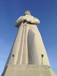 Low angle view of statue against blue sky