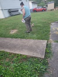 Side view of young man standing on footpath