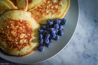 High angle view of pancakes and blueberries on plate