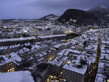 High angle view of illuminated city against sky during winter