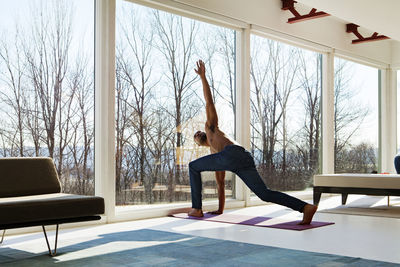 Man practicing yoga at home