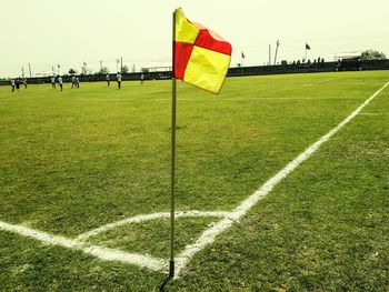 Scenic view of soccer field against clear sky