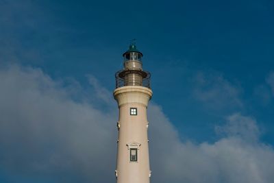 Low angle view of lighthouse against cloudy sky during sunny day