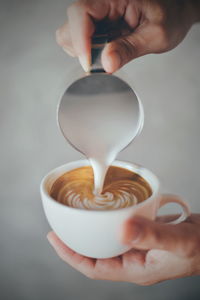 Cropped image of hand holding coffee cup